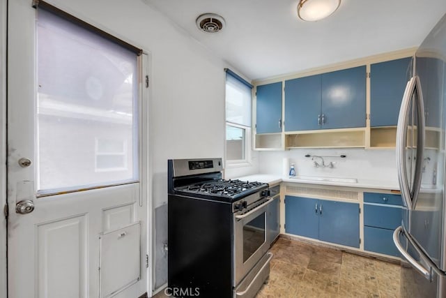 3618 Maine Ave, Long Beach, CA 90806 - kitchen with blue cabinets, stainless steel appliances, a sink, open shelves, and light countertops