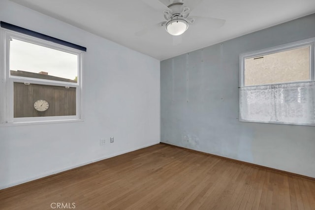 3618 Maine Ave, Long Beach, CA 90806 - empty room with healthy amount of natural light, wood finished floors, ceiling fan, and baseboards