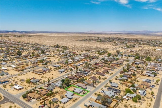 6064 Cahuilla Ave Unit 29, Palms, CA 92277 - aerial view of property's location featuring a desert landscape, a mountain backdrop, and nearby suburban area