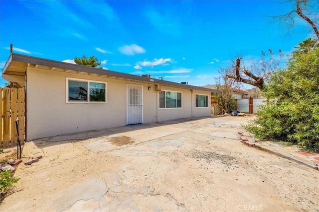 6064 Cahuilla Ave Unit 29, Palms, CA 92277 - view of front facade with stucco siding and a patio area