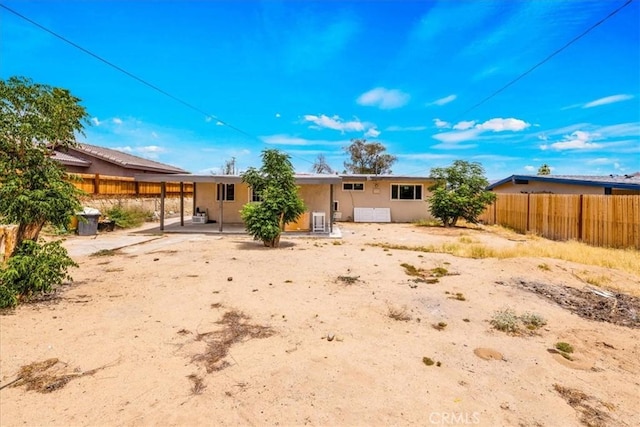 6064 Cahuilla Ave Unit 29, Palms, CA 92277 - back of property with stucco siding and a patio area