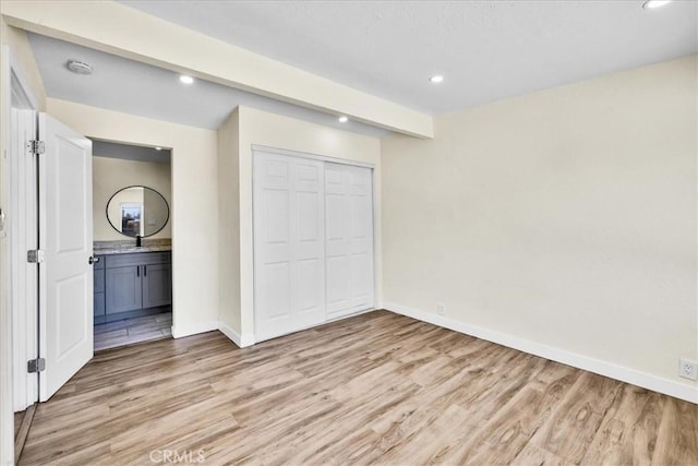 6064 Cahuilla Ave Unit 29, Palms, CA 92277 - unfurnished bedroom featuring light wood-type flooring, baseboards, recessed lighting, a closet, and a sink