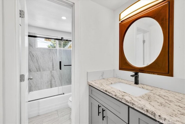 6064 Cahuilla Ave Unit 29, Palms, CA 92277 - bathroom featuring vanity, toilet, and shower / bath combination with glass door