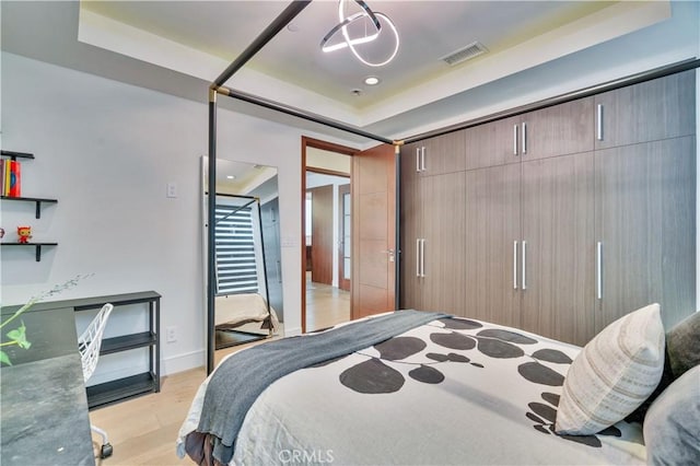 719 1st Pl, Hermosa Beach, CA 90254 - bedroom with a tray ceiling, light wood-style flooring, recessed lighting, and baseboards