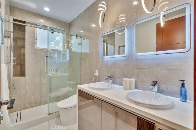 719 1st Pl, Hermosa Beach, CA 90254 - bathroom featuring tile walls, toilet, a shower stall, and double vanity