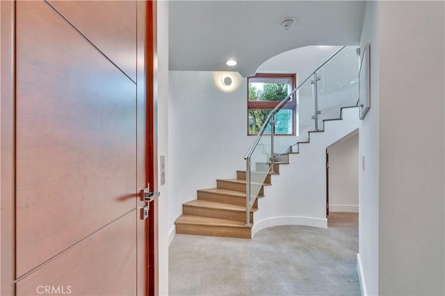 719 1st Pl, Hermosa Beach, CA 90254 - staircase with baseboards, arched walkways, finished concrete floors, and recessed lighting
