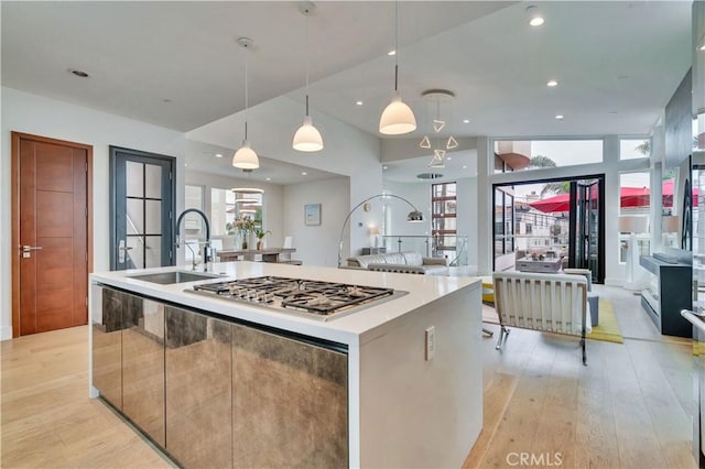 719 1st Pl, Hermosa Beach, CA 90254 - kitchen with a sink, light wood-type flooring, a large island with sink, modern cabinets, and stainless steel gas cooktop