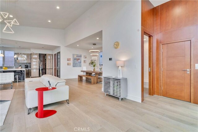 719 1st Pl, Hermosa Beach, CA 90254 - living room with wood finished floors, a towering ceiling, baseboards, and recessed lighting