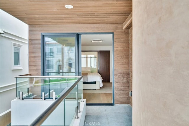 719 1st Pl, Hermosa Beach, CA 90254 - hall with wooden walls, wood ceiling, plenty of natural light, and light tile patterned floors