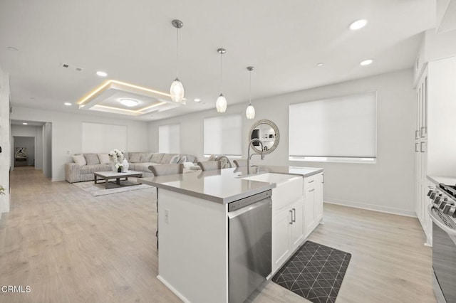 2850 Wagon Wheel Rd Unit 302, Oxnard, CA 93036 - kitchen with appliances with stainless steel finishes, white cabinetry, light wood finished floors, a sink, and recessed lighting