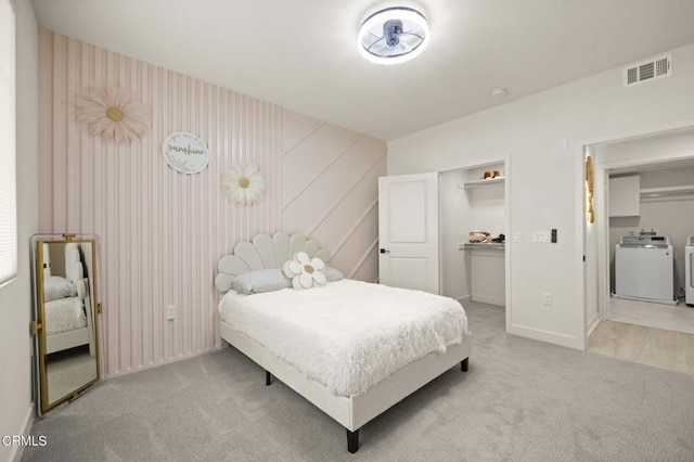 2850 Wagon Wheel Rd Unit 302, Oxnard, CA 93036 - bedroom featuring washing machine and dryer, carpet floors, baseboards, a spacious closet, and a closet