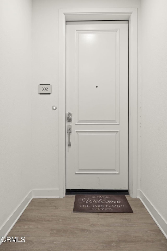 2850 Wagon Wheel Rd Unit 302, Oxnard, CA 93036 - doorway with baseboards and wood finished floors