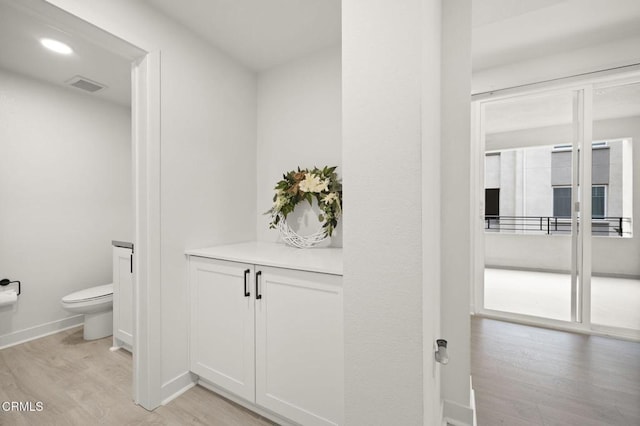 2850 Wagon Wheel Rd Unit 302, Oxnard, CA 93036 - bathroom with wood finished floors, toilet, and baseboards