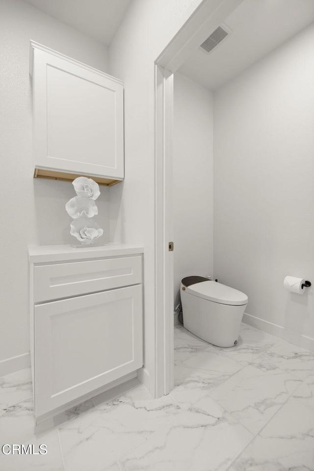 2850 Wagon Wheel Rd Unit 302, Oxnard, CA 93036 - bathroom with marble finish floors, toilet, and baseboards