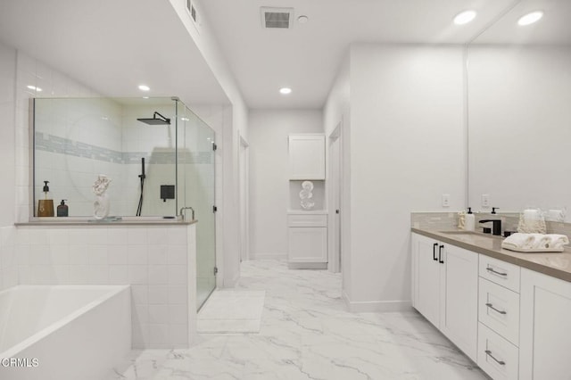 2850 Wagon Wheel Rd Unit 302, Oxnard, CA 93036 - bathroom with a bath, a shower stall, marble look tile flooring, vanity, and recessed lighting