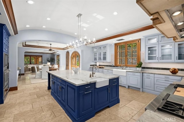 97 Canyon Crk, Irvine, CA 92603 - kitchen with arched walkways, a sink, a ceiling fan, recessed lighting, and stone tile flooring