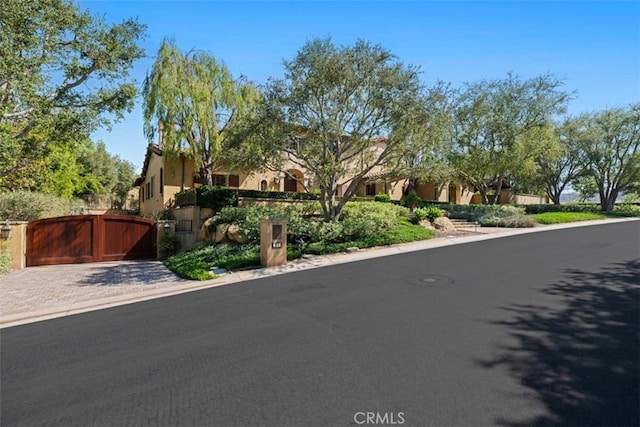 97 Canyon Crk, Irvine, CA 92603 - view of front of house with a gate and stucco siding