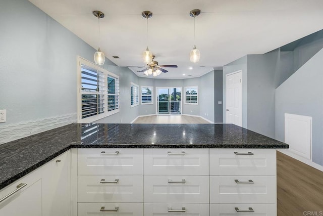 644 Grant St, Oceanside, CA 92054 - kitchen featuring a ceiling fan, a peninsula, dark stone countertops, and white cabinetry