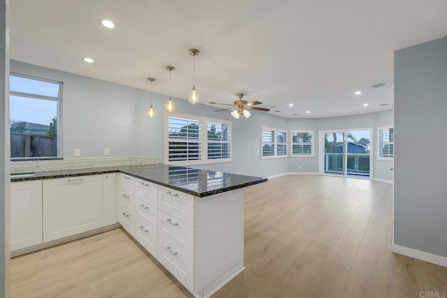 644 Grant St, Oceanside, CA 92054 - kitchen with a peninsula, ceiling fan, dark stone countertops, light wood-type flooring, and healthy amount of natural light