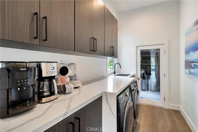 30402 Marbella, San Juan Capistrano, CA 92675 - kitchen with separate washer and dryer, dark wood-type flooring, light stone countertops, dark brown cabinetry, and modern cabinets