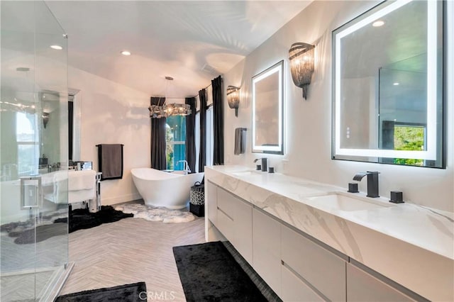 30402 Marbella, San Juan Capistrano, CA 92675 - full bath featuring a stall shower, double vanity, a freestanding bath, a chandelier, and recessed lighting