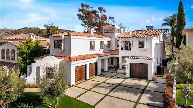 30402 Marbella, San Juan Capistrano, CA 92675 - view of front facade with concrete driveway, a garage, stucco siding, and a tiled roof
