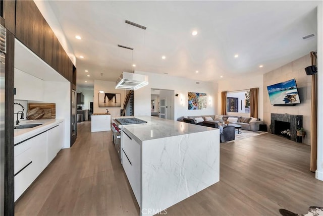 30402 Marbella, San Juan Capistrano, CA 92675 - kitchen featuring modern cabinets, high end stove, white cabinetry, wood finished floors, and open floor plan