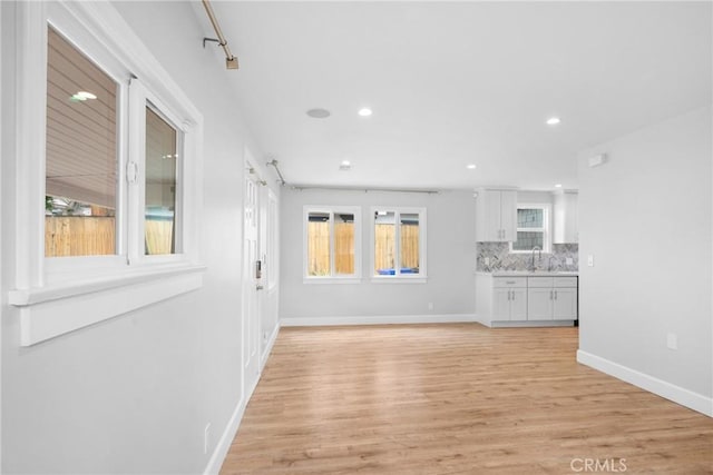 5624 Freeman Ave, La Crescenta, CA 91214 - unfurnished living room featuring light wood-style floors, baseboards, a sink, and recessed lighting