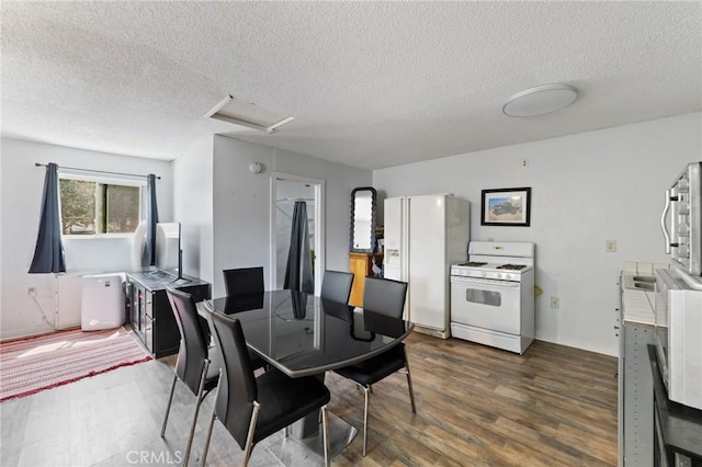 14650 Harding St, Hesperia, CA 92345 - dining area featuring attic access, dark wood-style floors, and a textured ceiling
