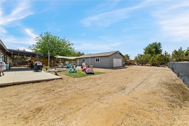 14650 Harding St, Hesperia, CA 92345 - view of yard featuring a patio and an outbuilding