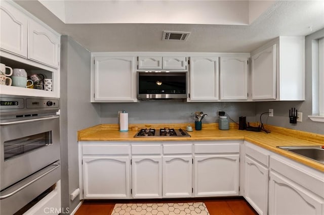 14650 Harding St, Hesperia, CA 92345 - kitchen featuring appliances with stainless steel finishes, a warming drawer, white cabinetry, light countertops, and a sink