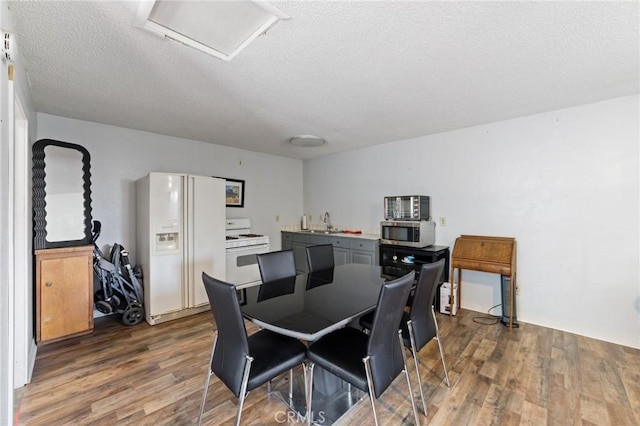 14650 Harding St, Hesperia, CA 92345 - dining area featuring attic access, dark wood-style flooring, and a textured ceiling