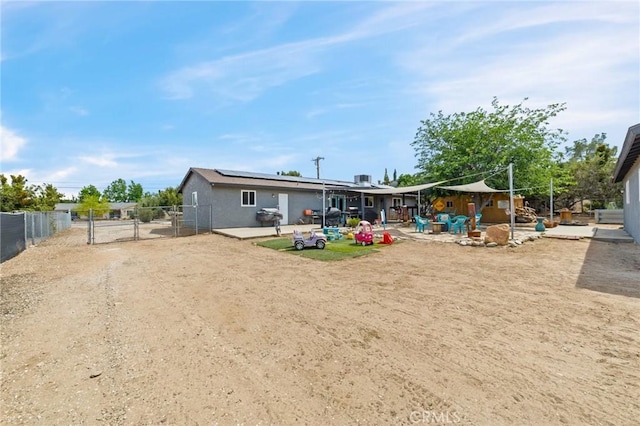 14650 Harding St, Hesperia, CA 92345 - rear view of house with a gate, a patio area, solar panels, and a fenced backyard