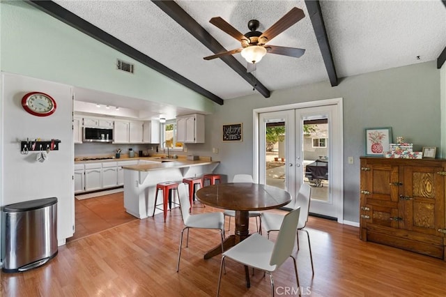 14650 Harding St, Hesperia, CA 92345 - dining space with a textured ceiling, plenty of natural light, light wood-style floors, and french doors