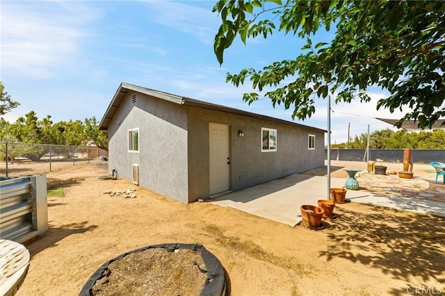 14650 Harding St, Hesperia, CA 92345 - view of side of property with stucco siding and a patio area
