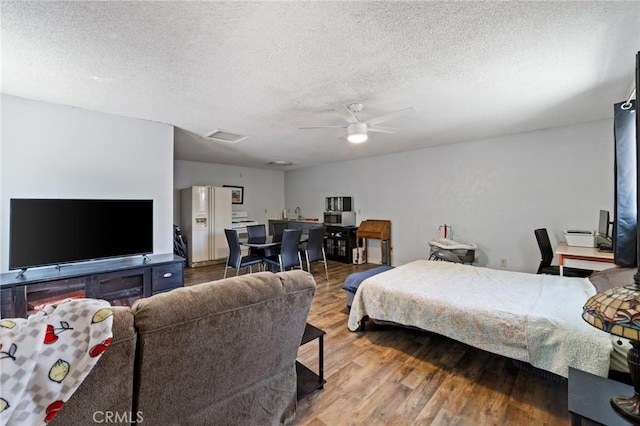 14650 Harding St, Hesperia, CA 92345 - bedroom with wood finished floors, a textured ceiling, and a ceiling fan
