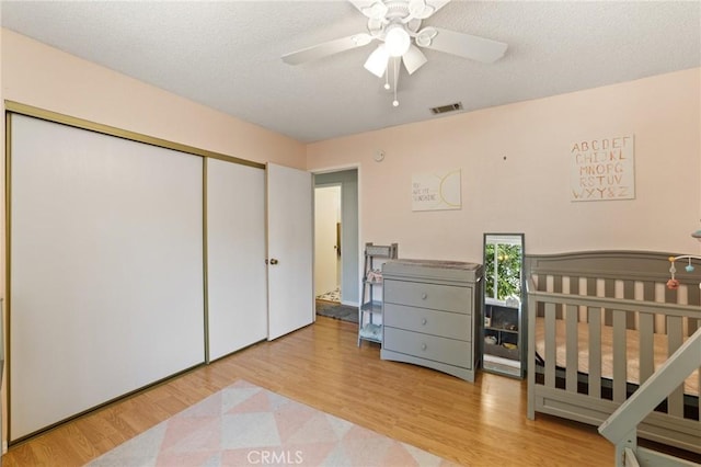 14650 Harding St, Hesperia, CA 92345 - bedroom with a closet, wood finished floors, a ceiling fan, and a textured ceiling