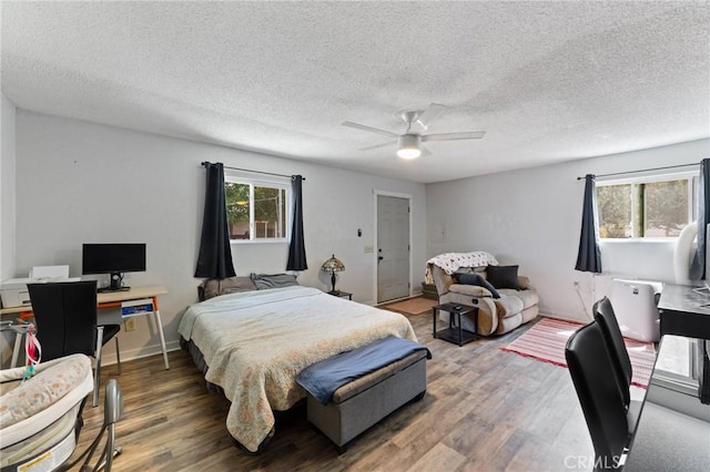 14650 Harding St, Hesperia, CA 92345 - bedroom with wood finished floors, a desk, a textured ceiling, and a ceiling fan