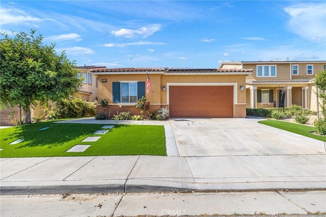 1316 Bannock St, Beaumont, CA 92223 - mediterranean / spanish house featuring stucco siding, an attached garage, a front yard, concrete driveway, and solar panels