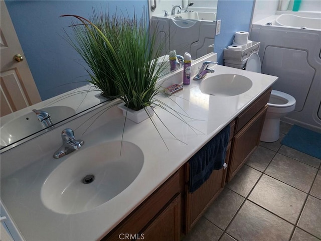21224 Vidal Ct, Apple Valley, CA 92308 - bathroom featuring toilet, double vanity, tile patterned flooring, and a bathtub