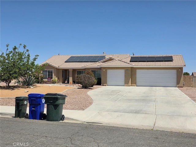 21224 Vidal Ct, Apple Valley, CA 92308 - view of front of home featuring a tile roof, a garage, and solar panels