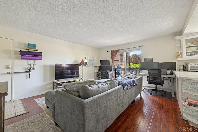 155 Rosebay Dr Unit 42, Encinitas, CA 92024 - living area featuring a desk, dark wood-type flooring, a textured ceiling, and baseboards