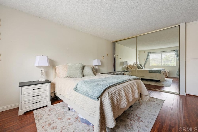 155 Rosebay Dr Unit 42, Encinitas, CA 92024 - bedroom with dark wood-style flooring, a textured ceiling, and baseboards