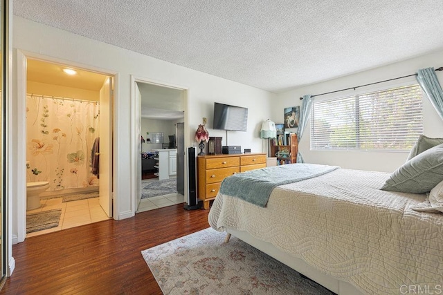 155 Rosebay Dr Unit 42, Encinitas, CA 92024 - bedroom featuring wood finished floors, a textured ceiling, and ensuite bath