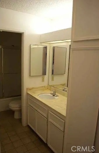 6188 Agee St Unit 230, San Diego, CA 92122 - bathroom with toilet, vanity, tile patterned flooring, a textured ceiling, and shower / bathtub combination