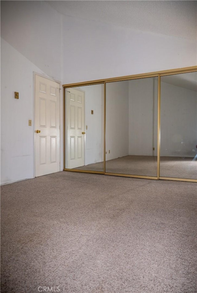 6188 Agee St Unit 230, San Diego, CA 92122 - unfurnished bedroom featuring vaulted ceiling, carpet, and a closet