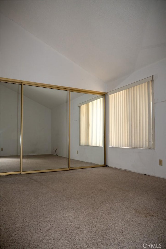 6188 Agee St Unit 230, San Diego, CA 92122 - unfurnished bedroom with carpet, lofted ceiling, and a closet