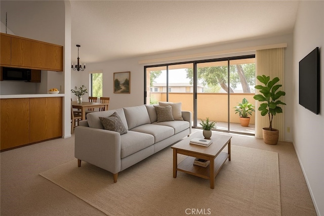6188 Agee St Unit 230, San Diego, CA 92122 - living room with healthy amount of natural light, light colored carpet, and a chandelier