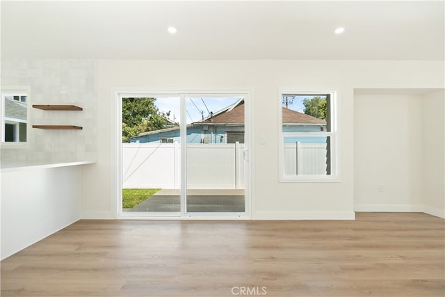 1027 E 10th St, Long Beach, CA 90813 - empty room with light wood-style flooring, healthy amount of natural light, and recessed lighting