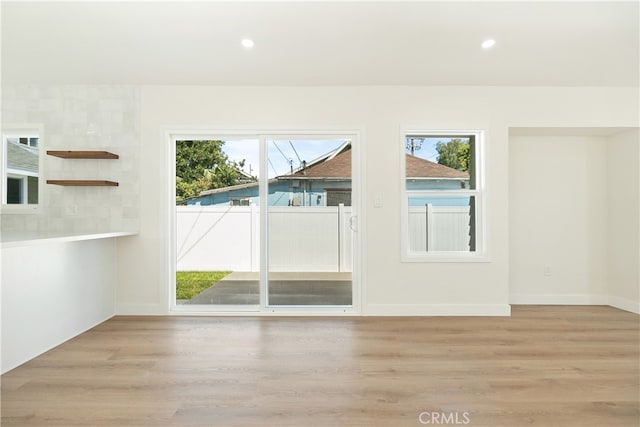 1027 E 10th St, Long Beach, CA 90813 - empty room featuring light wood-style flooring, healthy amount of natural light, and recessed lighting
